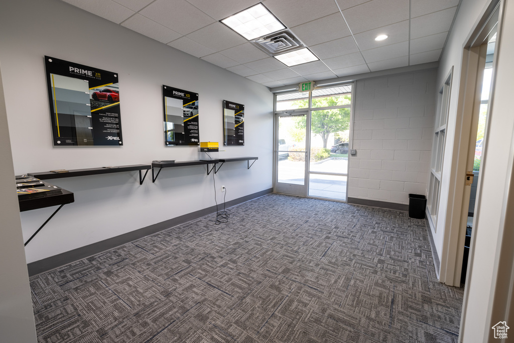 Office with dark colored carpet, baseboards, a drop ceiling, and recessed lighting
