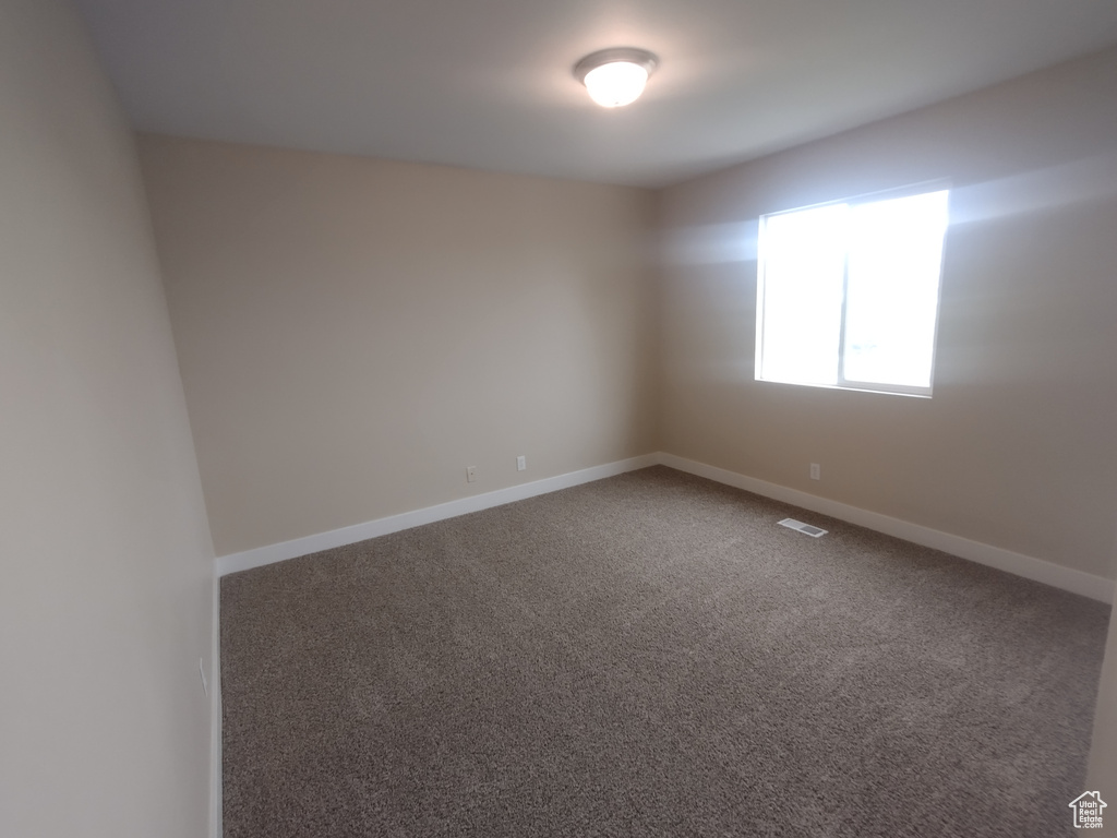 Unfurnished room with carpet floors and baseboards