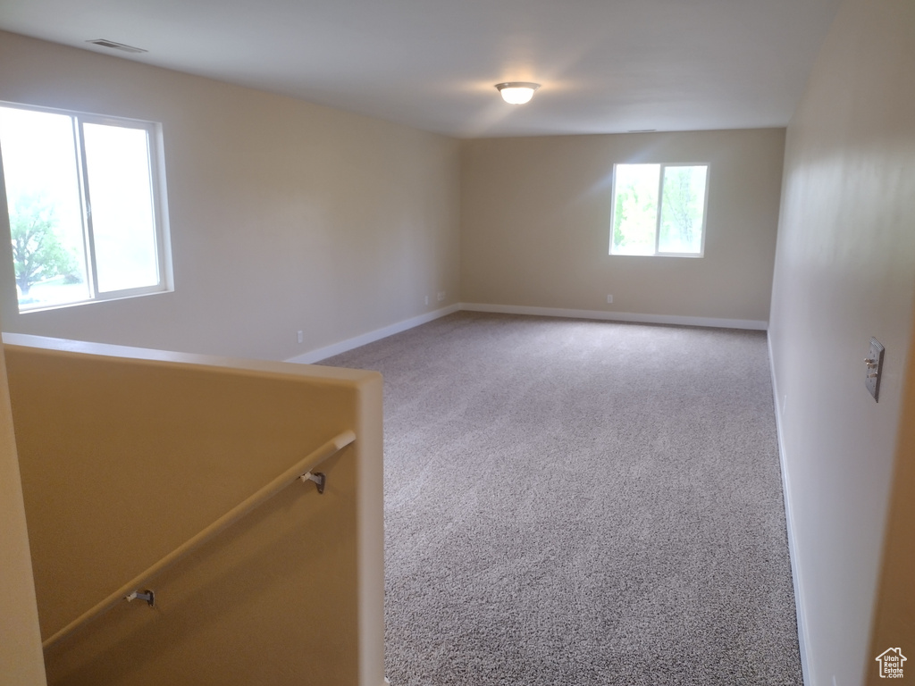 Empty room featuring carpet flooring and baseboards