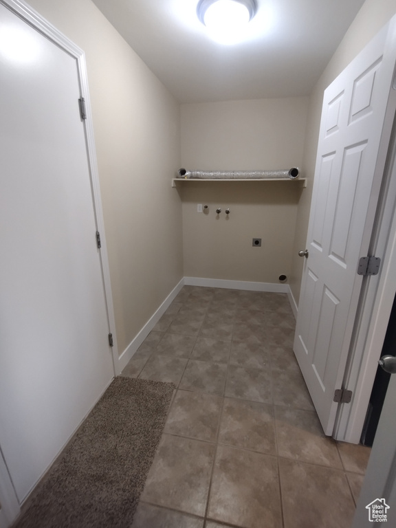 Washroom featuring electric dryer hookup, gas dryer hookup, and baseboards