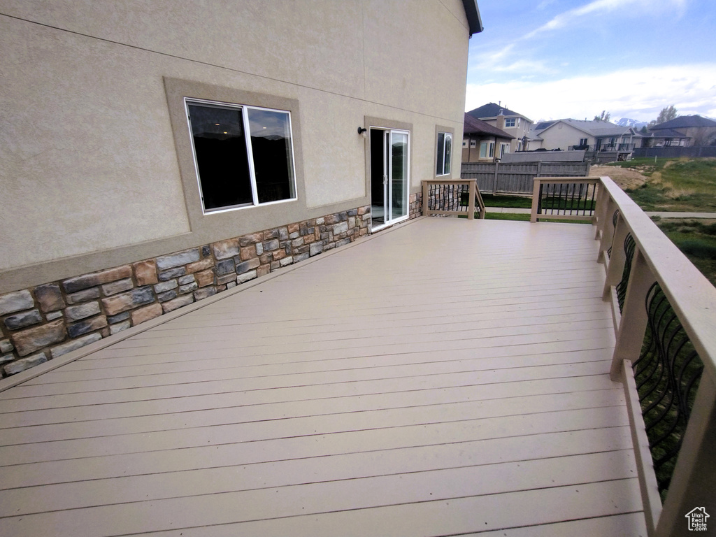 Deck featuring fence and a residential view