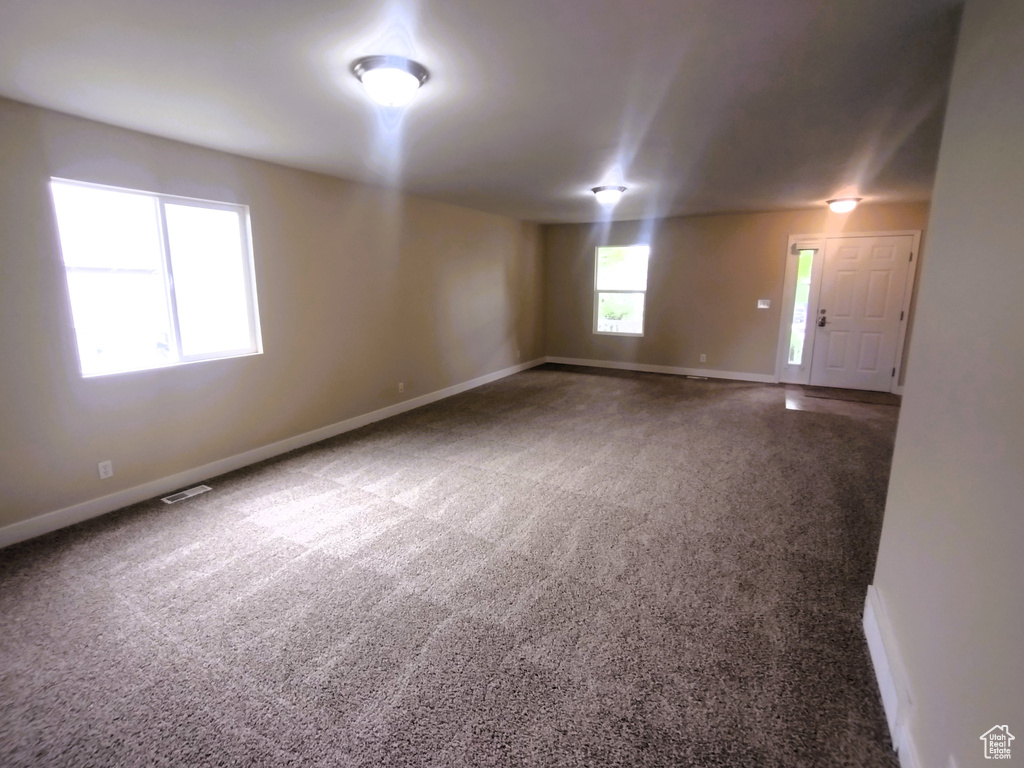 Carpeted spare room with baseboards