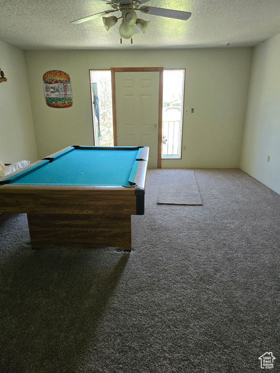 Game room with healthy amount of natural light, a ceiling fan, a textured ceiling, billiards, and carpet flooring