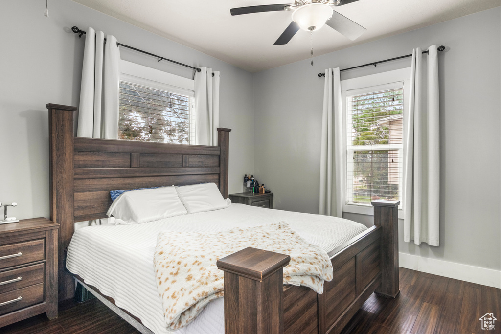 Bedroom with dark wood-style floors and baseboards
