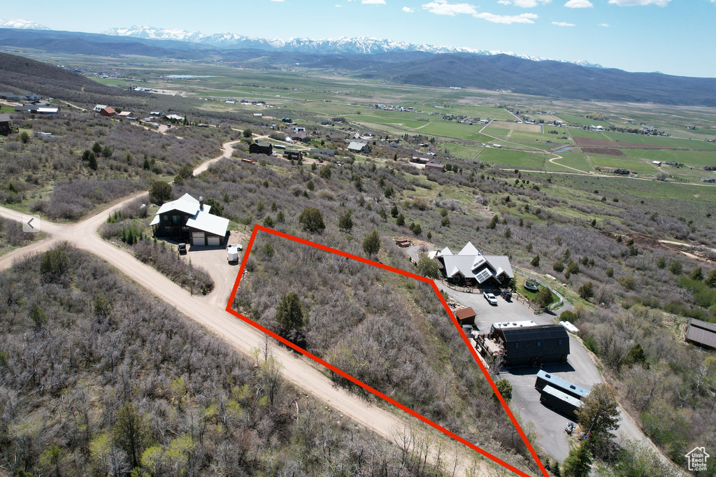 Overview of rural landscape with a mountainous background and property boundaries highlighted