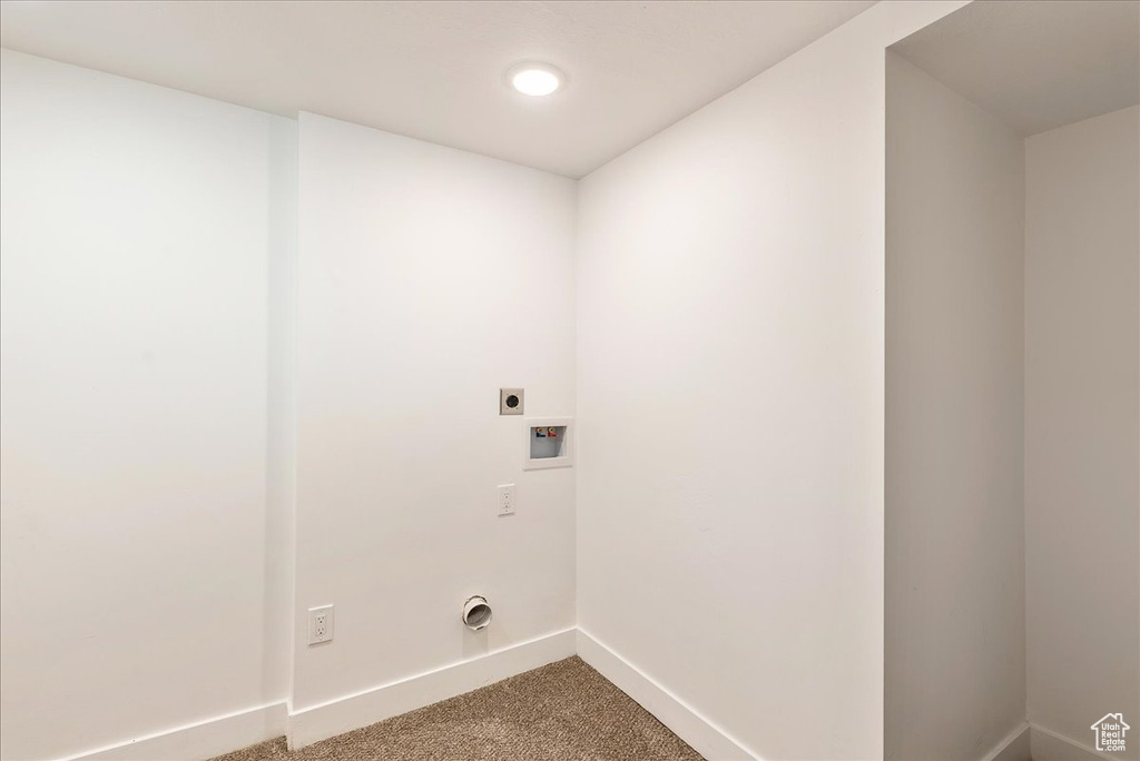 Clothes washing area featuring hookup for an electric dryer, baseboards, hookup for a washing machine, and carpet