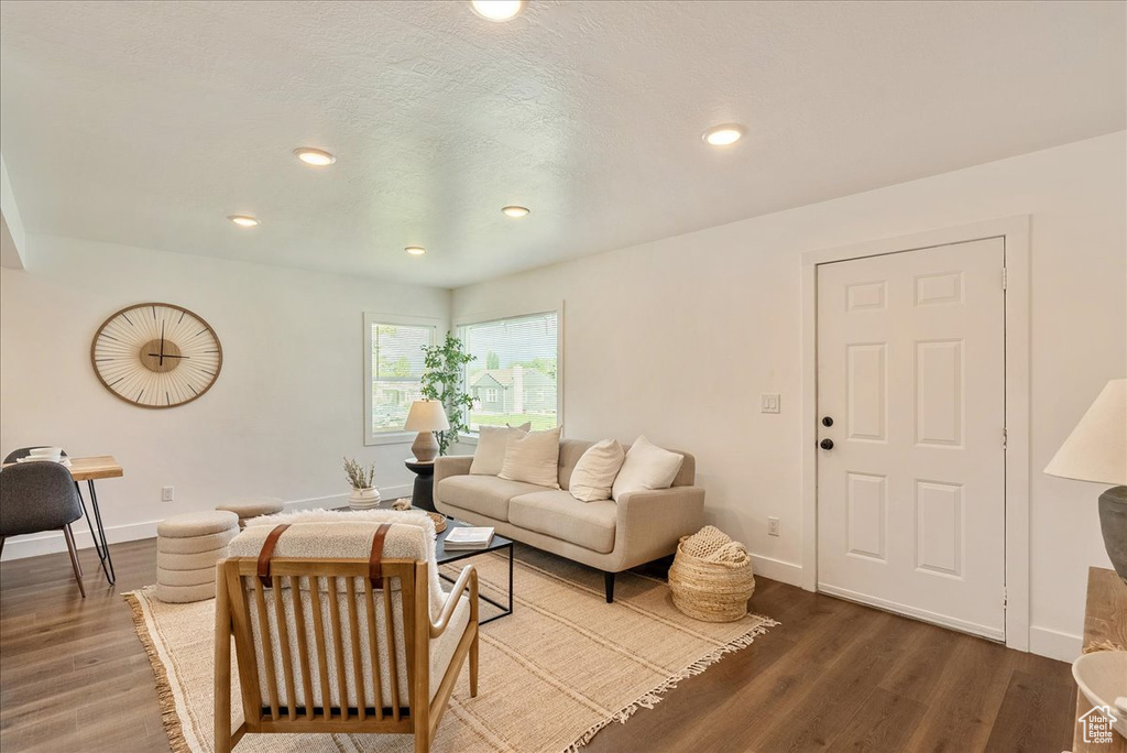 Living area featuring wood finished floors, baseboards, and recessed lighting