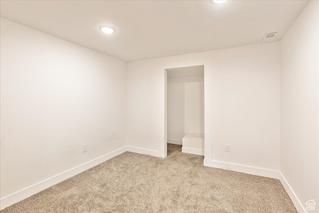 Unfurnished room with light carpet, baseboards, and recessed lighting