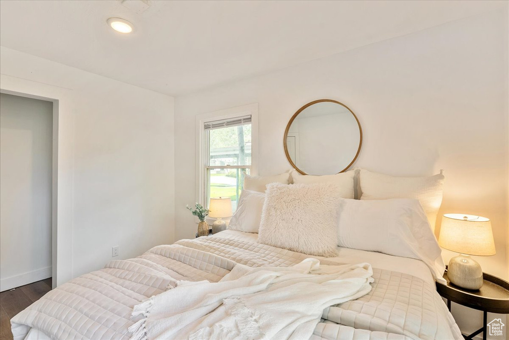 Bedroom with wood finished floors and baseboards