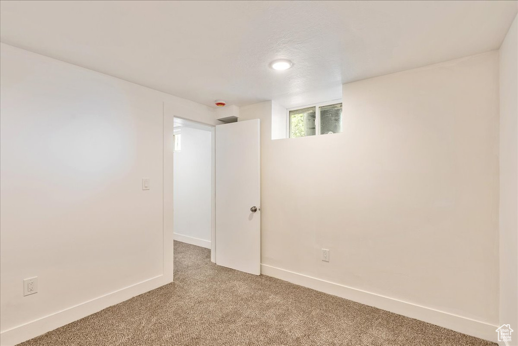 Unfurnished room with light carpet, baseboards, and recessed lighting
