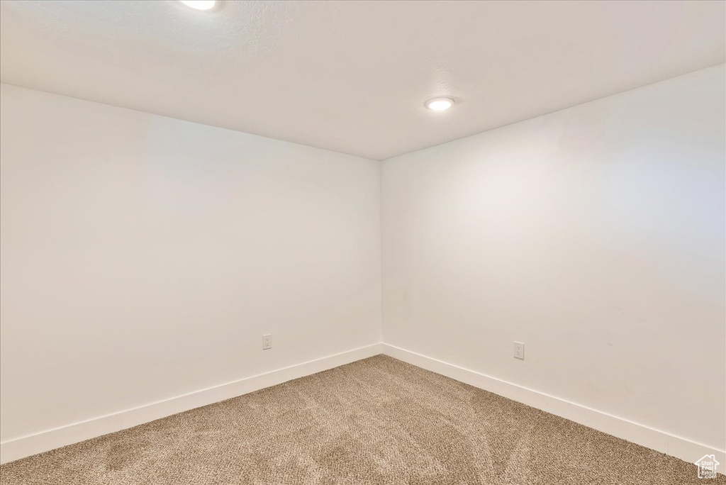 Spare room with light carpet, baseboards, and recessed lighting