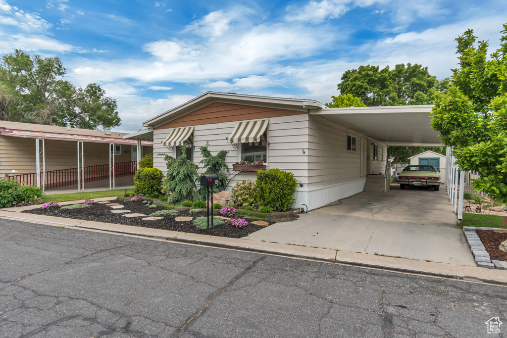 Manufactured / mobile home with a carport and concrete driveway