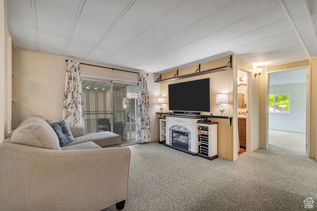 Living room featuring carpet and a fireplace