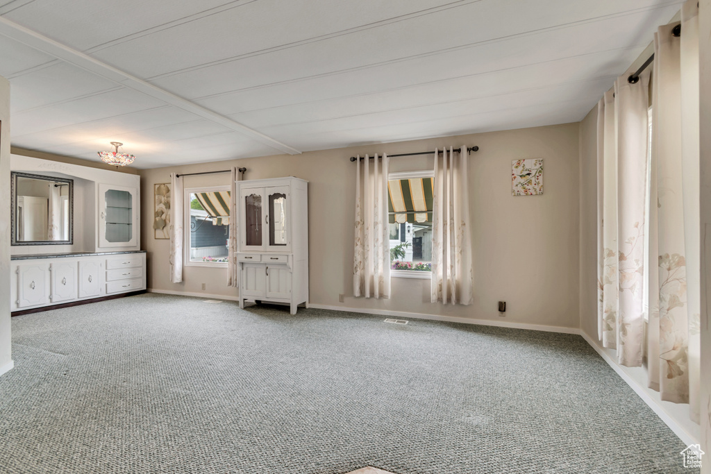 Carpeted spare room with baseboards