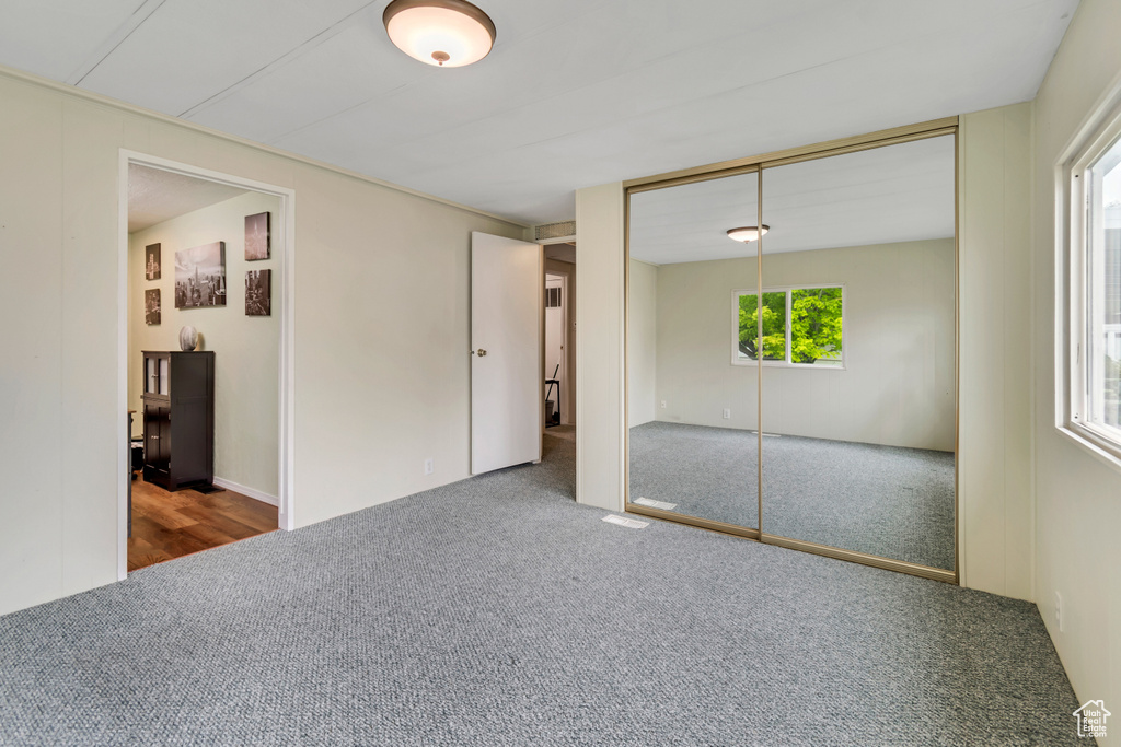 Unfurnished bedroom with carpet floors and a closet