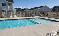 Community pool with fence and a patio area