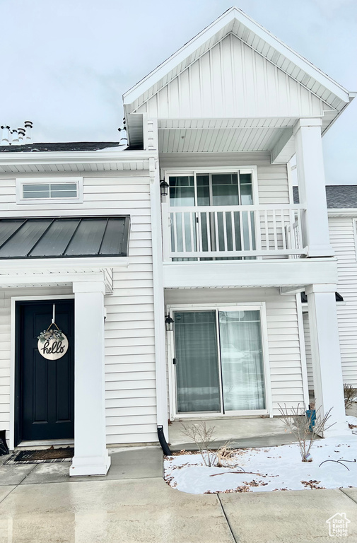 View of front of house featuring a balcony