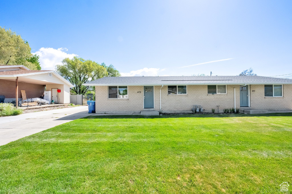 Ranch-style home with brick siding, a front lawn, and entry steps