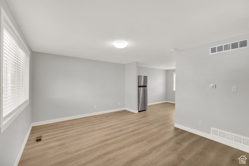 Empty room with light wood finished floors and baseboards