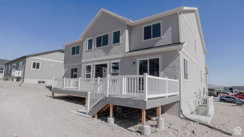 Back of property featuring stucco siding and a deck