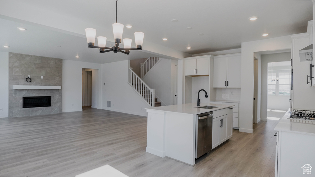 Kitchen featuring stainless steel appliances, a chandelier, light wood-style floors, recessed lighting, and white cabinets