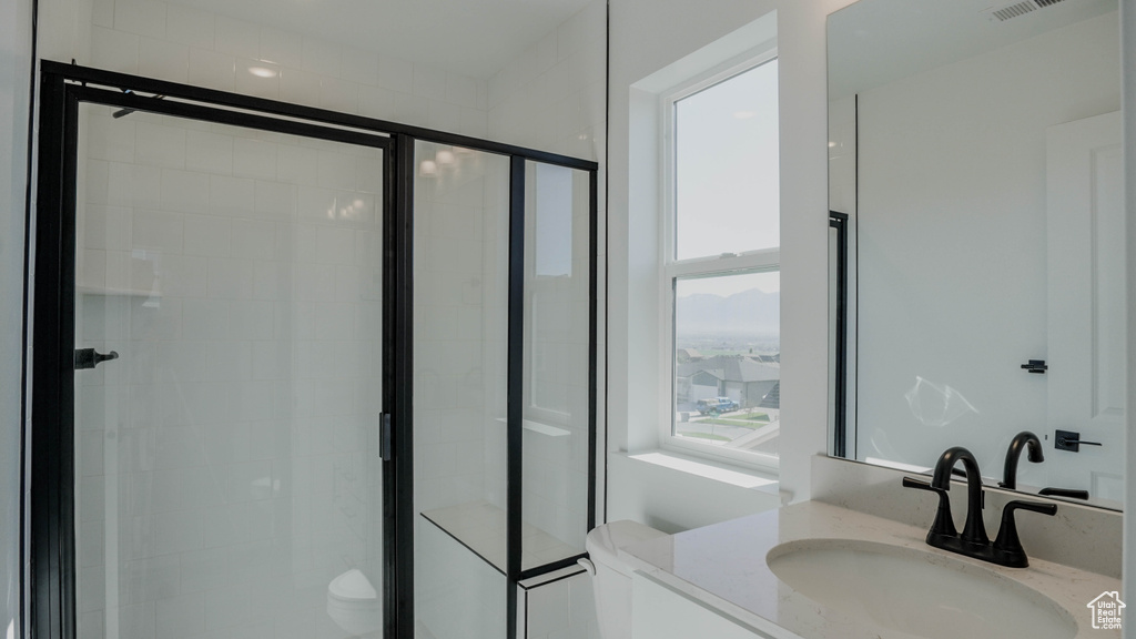 Full bath featuring vanity and a shower stall
