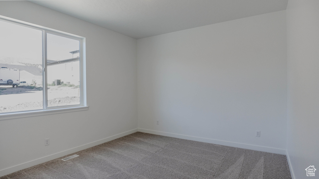 Unfurnished room featuring carpet flooring