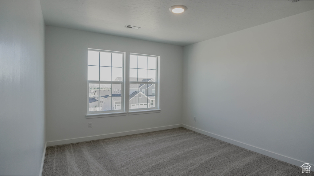 Unfurnished room with carpet and baseboards