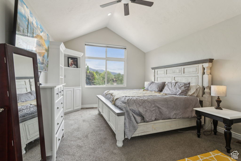 Bedroom featuring lofted ceiling, light carpet, a ceiling fan, and baseboards