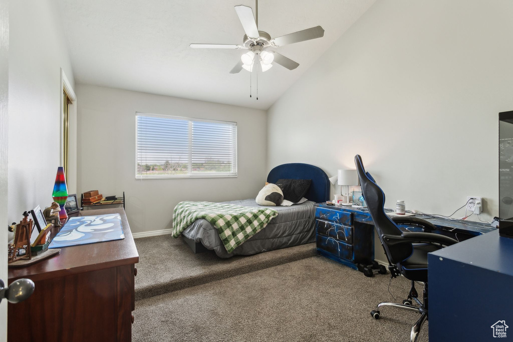 Bedroom with carpet floors, an office area, vaulted ceiling, baseboards, and a ceiling fan