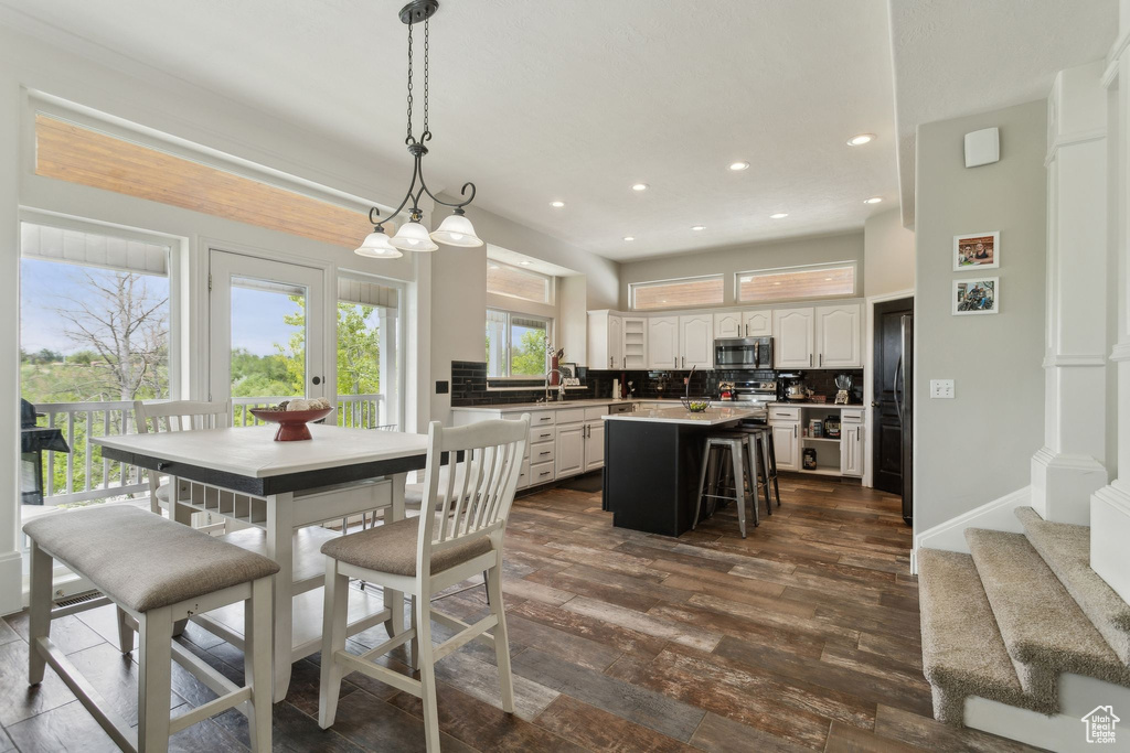 Dining room with dark wood-style floors, recessed lighting, and baseboards
