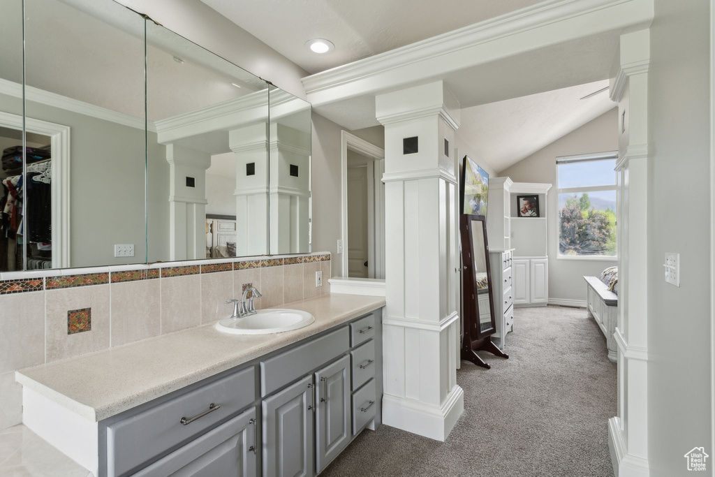 Bathroom featuring backsplash, vanity, recessed lighting, crown molding, and a spacious closet