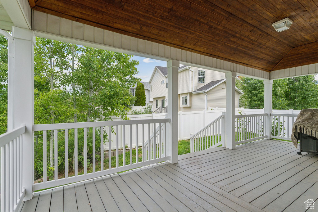 Wooden terrace with a residential view and fence