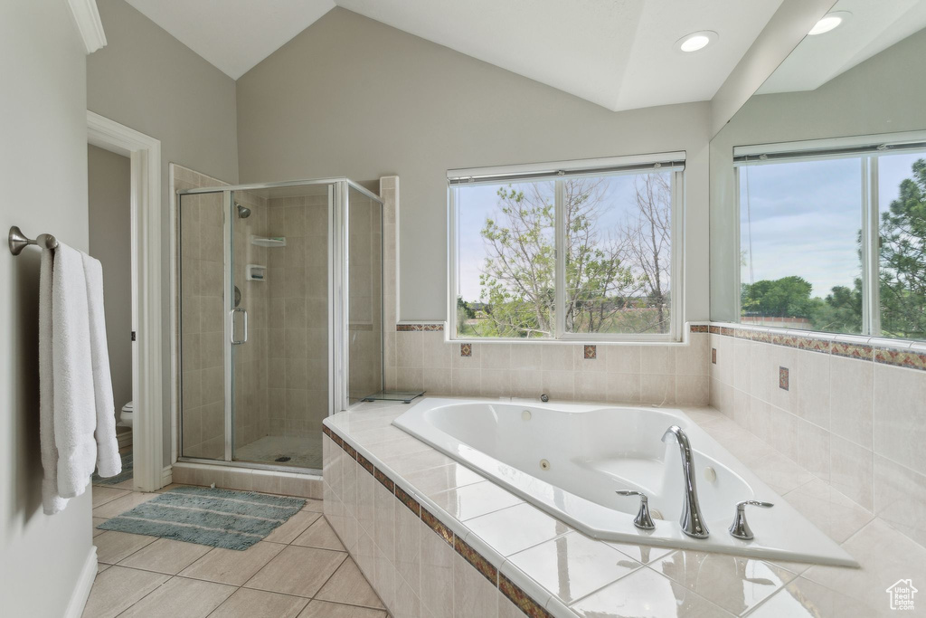 Bathroom with a stall shower, tile patterned floors, toilet, a jetted tub, and lofted ceiling