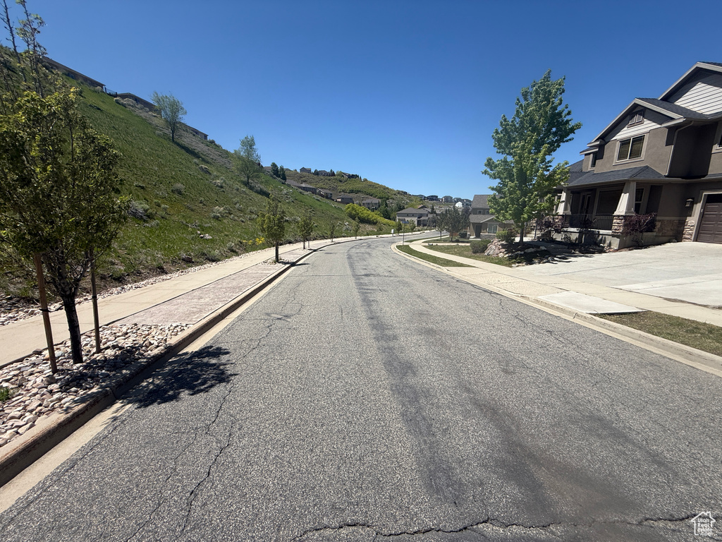 View of asphalt street with curbs and sidewalks