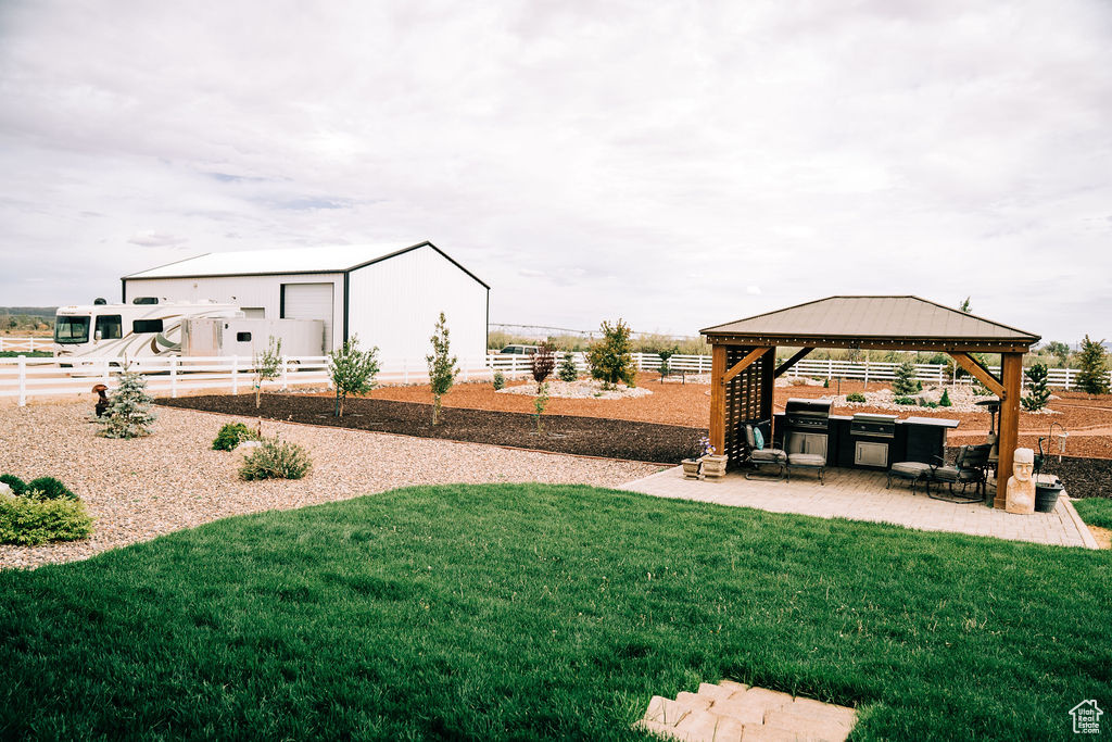 View of yard with a gazebo, a patio area, and an outdoor structure
