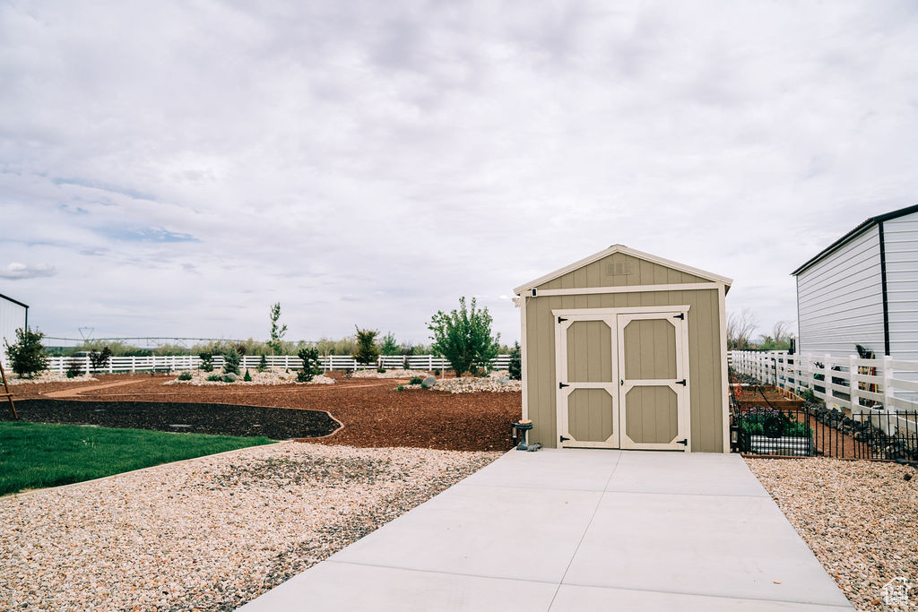 View of shed featuring fence