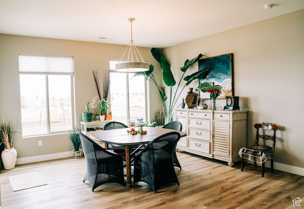 Dining area with light wood-style flooring and baseboards