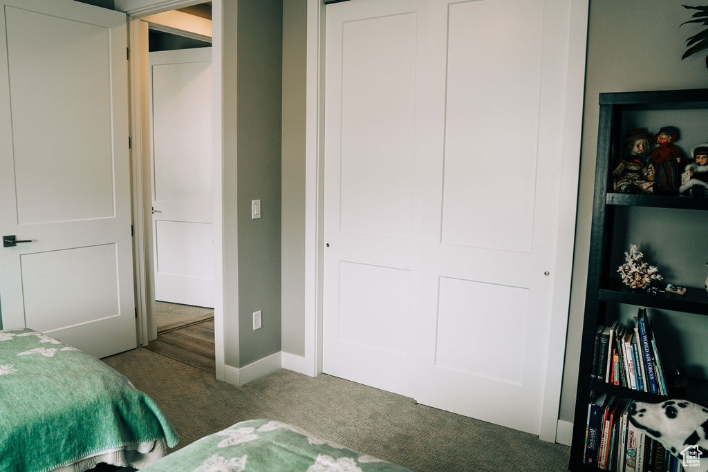 Carpeted bedroom featuring baseboards