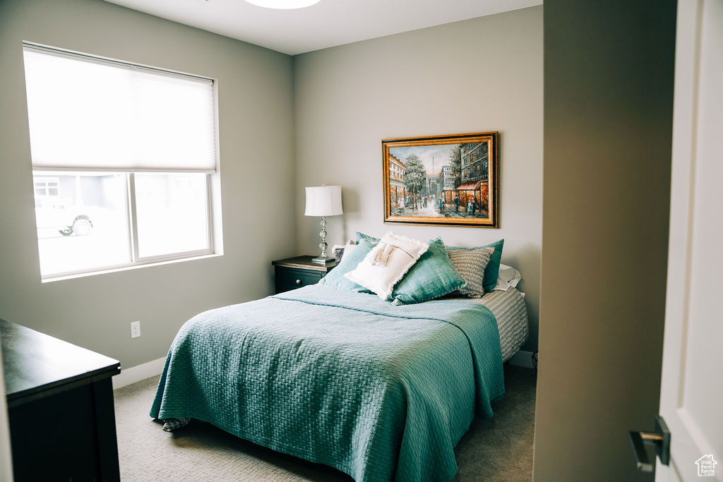 Carpeted bedroom featuring baseboards
