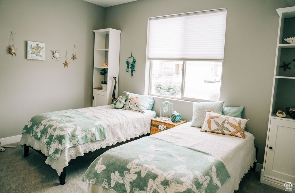 Bedroom featuring carpet floors and baseboards