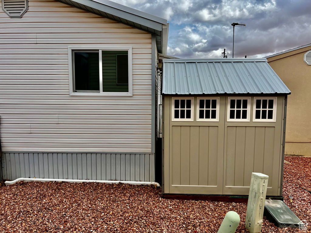 View of home\'s exterior with a storage shed, an outbuilding, and metal roof