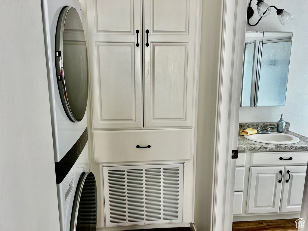 Clothes washing area with estacked washer and dryer and cabinet space