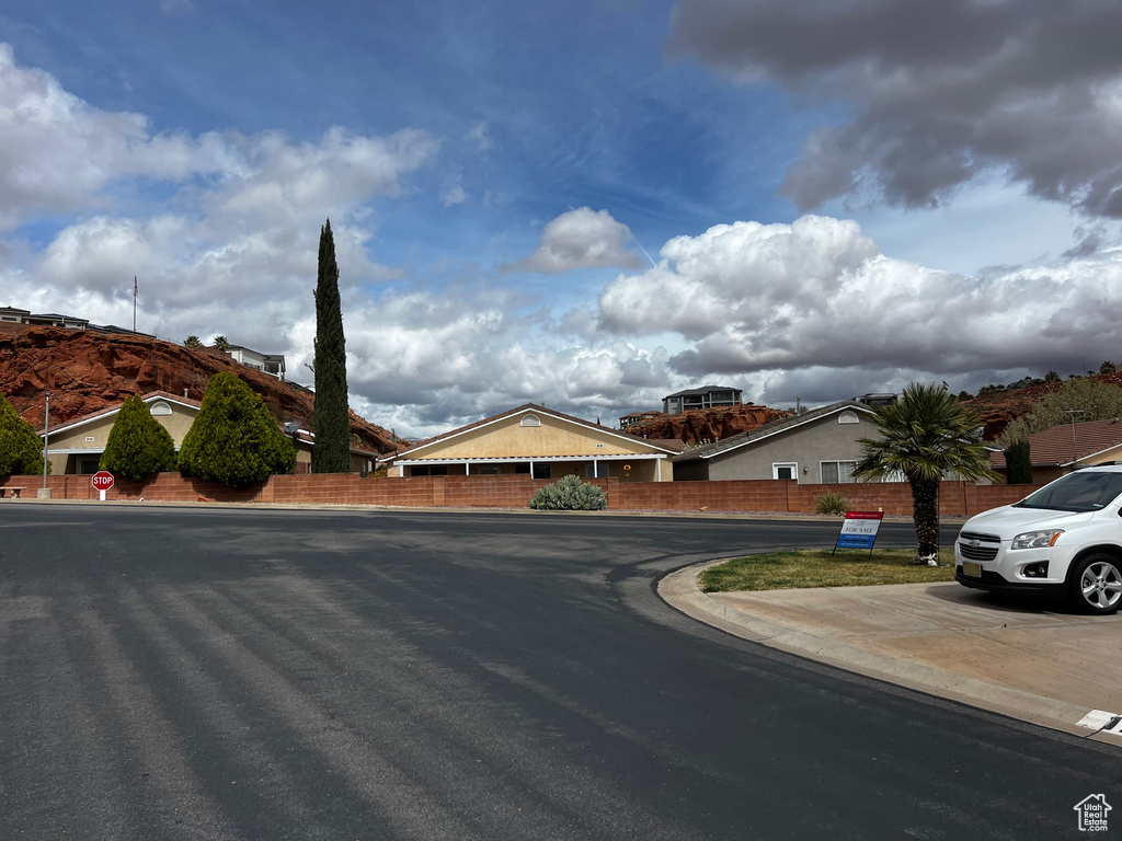 View of asphalt road featuring curbs