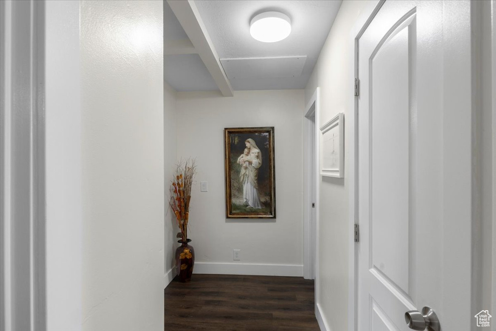 Hall featuring dark wood-style floors and baseboards