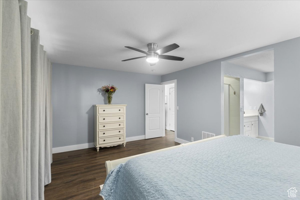 Bedroom featuring wood finished floors, baseboards, ensuite bathroom, and a ceiling fan
