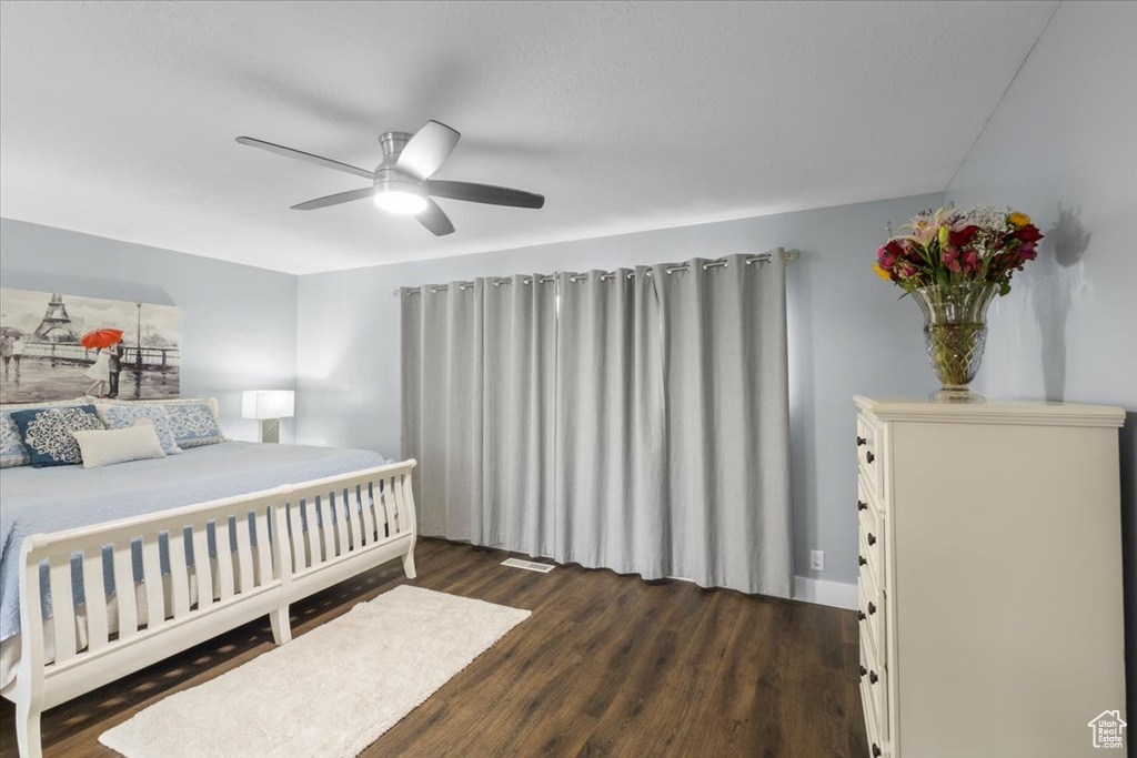 Bedroom with dark wood finished floors and ceiling fan