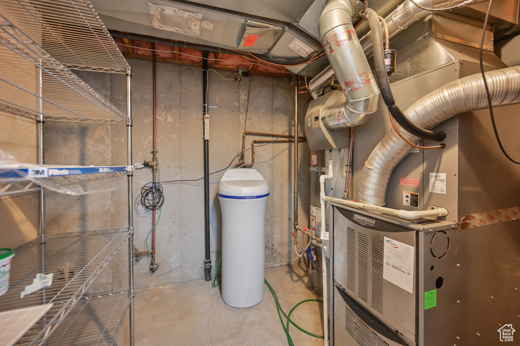 Utility room featuring heating unit