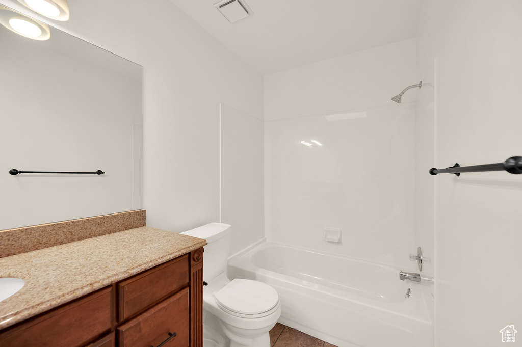 Full bathroom with vanity, toilet, shower / washtub combination, and tile patterned floors