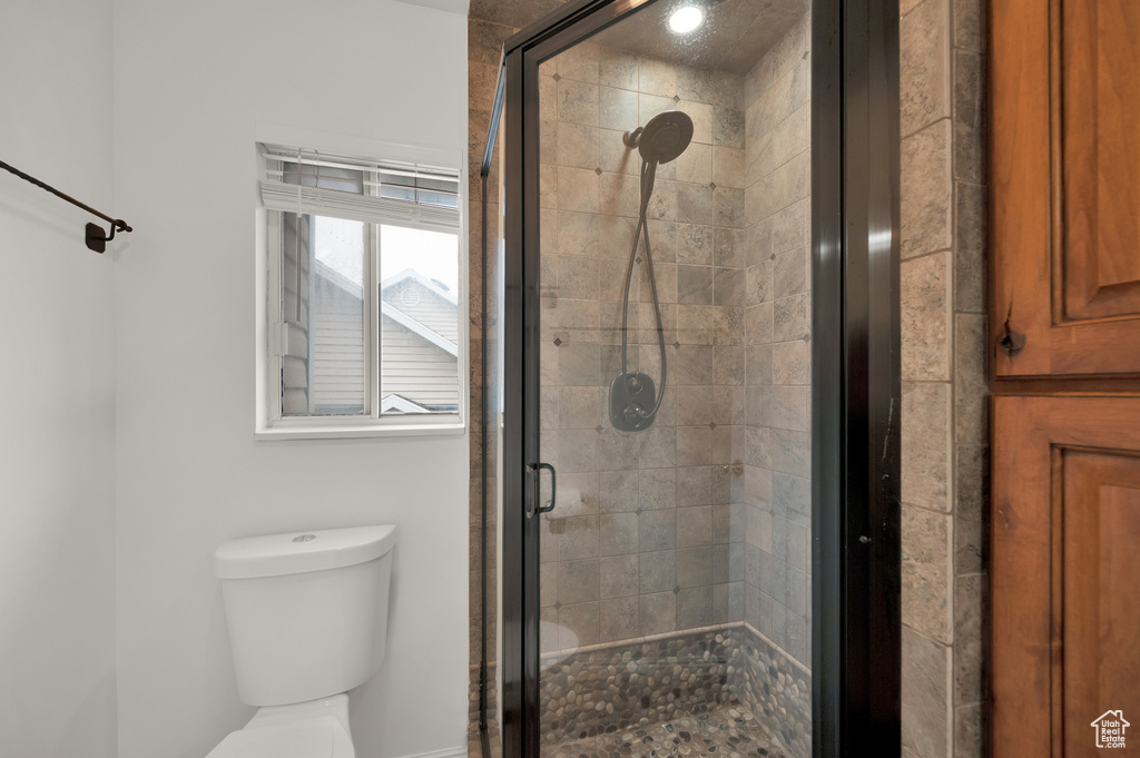 Full bathroom with a stall shower and toilet